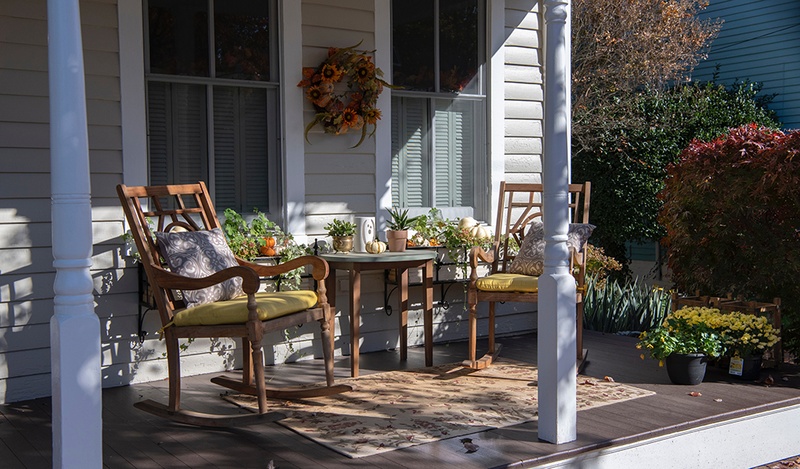 front porch with rocking chairs and table
