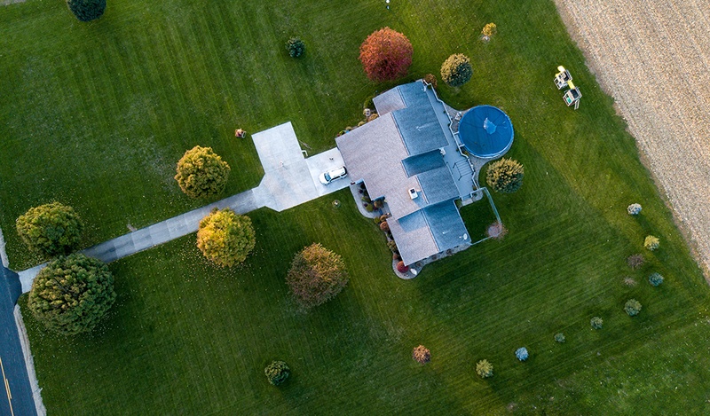 above ground shot with the house and surrounding land with trees