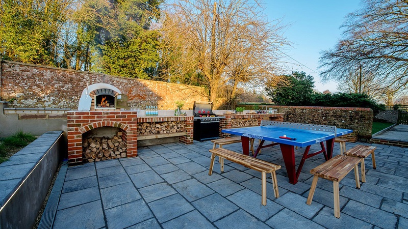 Outdoor kitchen and ping pong table in garden