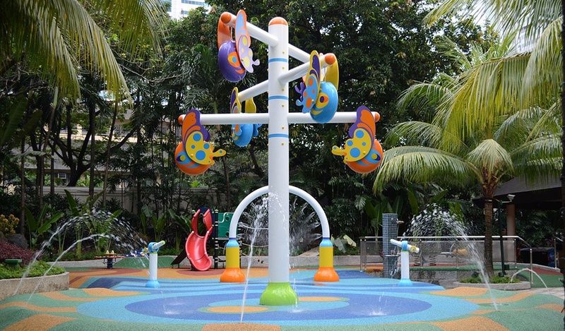 A children's playground with equipment and rubber surface.